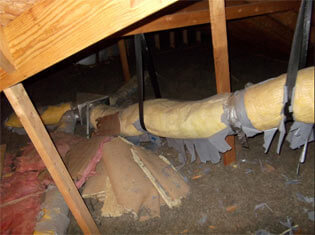 Before image of damaged ductwork in an attic.