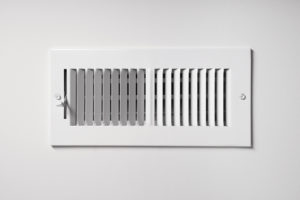Air vent on white wall of home