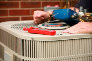 HVAC tools resting on top of an outdoor unit