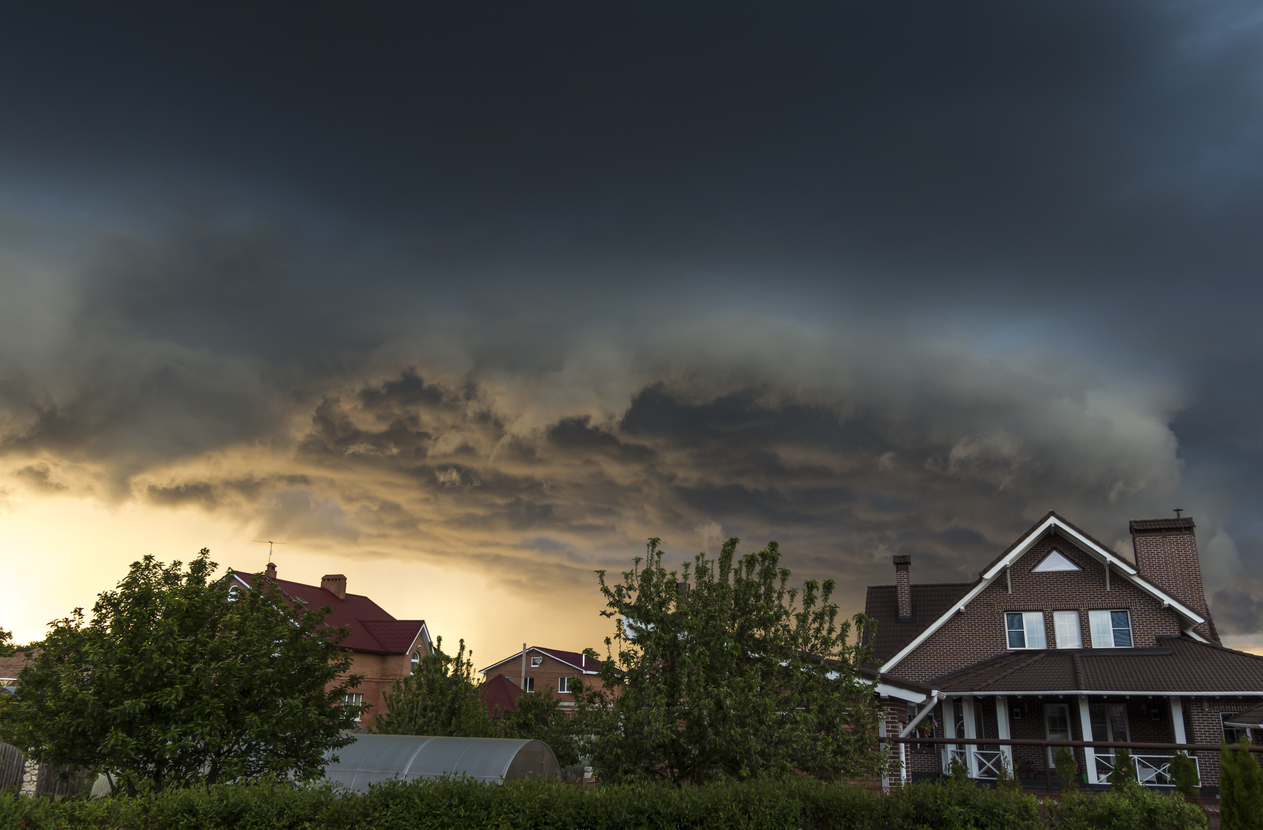 Summer storm clouds over brick home